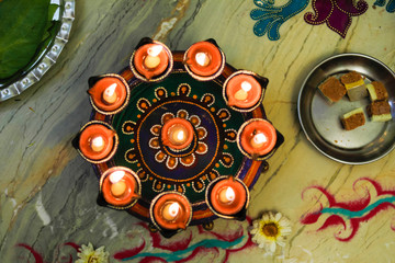 Indian wedding ceremony : Decorative oil lamp and sweet in dish