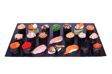 Set of Gunkan Maki Sushi with different types of fish salmon, scallop, perch, eel, shrimp and caviar on black stone isolated on white background. Sushi menu. Japanese food.