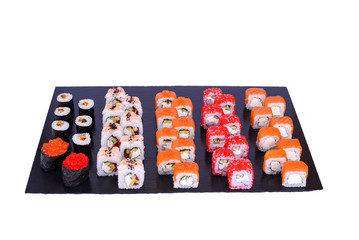 sushi set Okinawa rolls with fresh ingredients on black stone isolated on white background. Sushi menu. Japanese food.