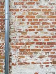 Background texture red old brick wall with a silver gutter