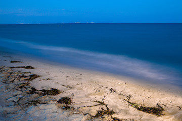Sea coast and beach at night. Pieria, Greece. Illuminated art concept.