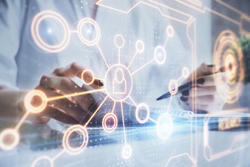 Social network theme hologram over woman's hands writing background. Concept of international people connect. Double exposure