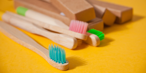 Eco bamboo kid colorful toothbrushes on the yellow background