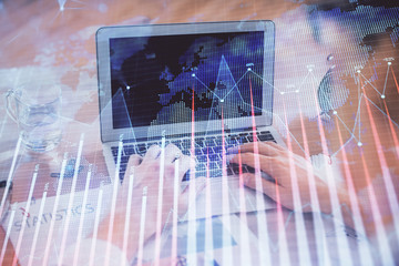 Multi exposure of market chart with man working on computer on background. Concept of financial analysis.