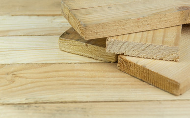 sawn boards lie on the wooden surface.Construction materials from pine