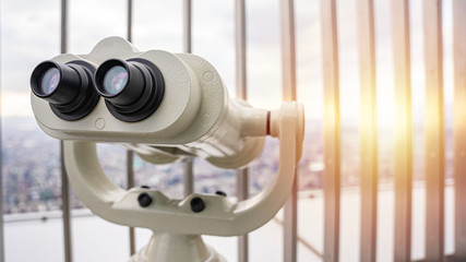 Telescope on top of the skyscraper's observation deck at sunset. 