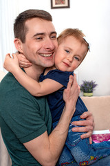 Shot of a young dad hugging a little daughter. The concept of family values.