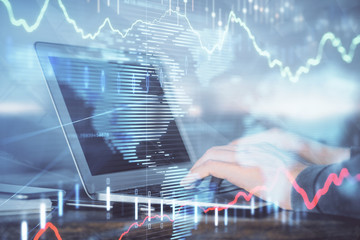Double exposure of stock market graph with man working on laptop on background. Concept of financial analysis.