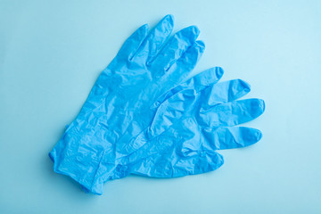 Disposable gloves on light blue background