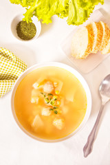 Pea soup in a white bowl with herbs. Top view.
