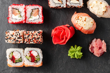 Japanese cuisine. Assorted sushi maki gunkan roll on white table