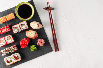 Japanese cuisine. Assorted sushi maki gunkan roll on white table