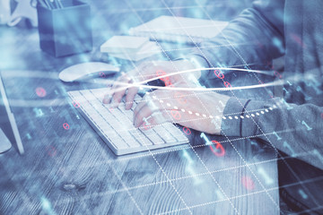 Multi exposure of financial graph with man works in office on background. Concept of analysis.