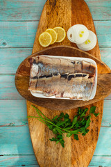 sliced salted herring on plate rings onion lemon