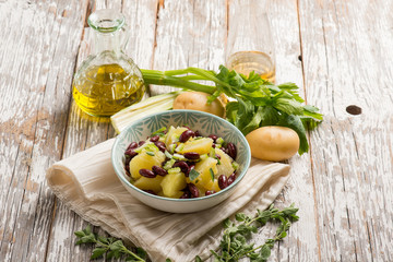 Obraz na płótnie Canvas potatoes salad with red beans oregano and celery