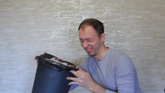 Crazy man delves into the bin that stinks.