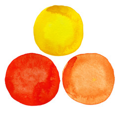 A set of yellow, orange and red hand-painted watercolors of round shapes isolated on a white background.