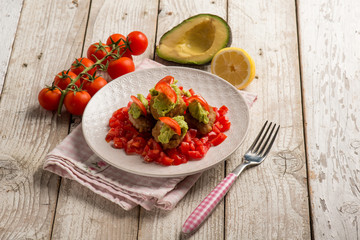 meatballs with fresh tomatoes salad and avocado cream