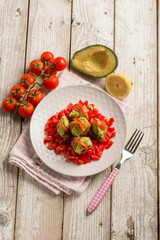 Fototapeta na wymiar meatballs with fresh tomatoes salad and avocado cream