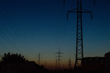 Fototapeta premium power lines against the background of the sunset sky