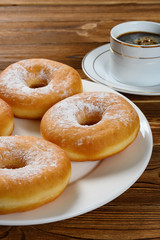 side view donuts with cup of coffee vertical composition