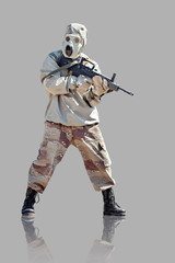 Fototapeta premium Soldier in protective clothes and mask with the rifle. Isolated on grey background.