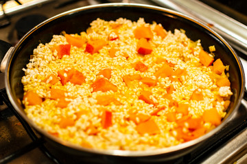Pumpkin and rice cooking in a pan for risotto