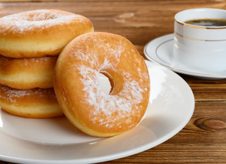 side view donuts with cup of coffee horizontal composition