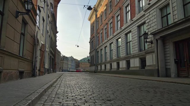 Deserted city due to quarantine, coronavirus effects. Walking alone along the cobbled street of Old Riga at dawn, Latvia