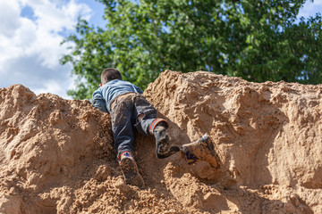 A boy plays in the sandbox.