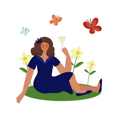 The girl is sitting on the grass with a glass of wine.