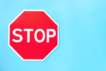 Red prohibition road sign stop on left part of blue background. Prevention warning symbol shows...