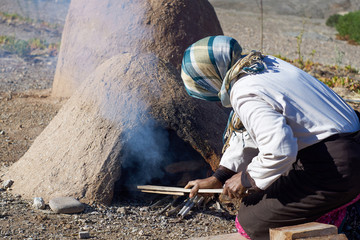 Cooking in traditional Moroccan earth ovens made of sandstone and mud