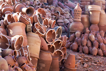 Clay jars and bowls on display in a market Morocco