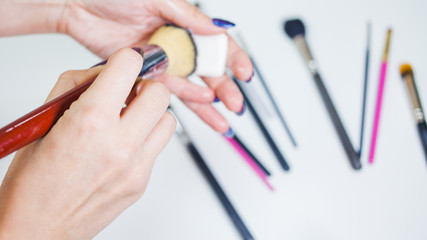 Hygienic care of makeup artist tools, women's hands wash the brush from cosmetics, soap and cleaning products,