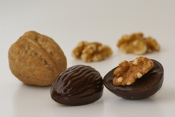 Decorated dark brown chocolate pralines filled organic walnuts