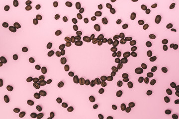 A cup of coffee made from coffee beans on a pink background.Coffee break. Coffee time