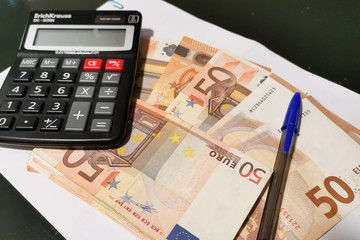 euro banknotes and calculator