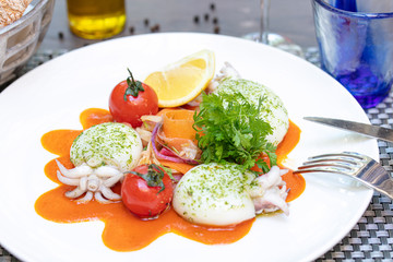 Plate of cuttlefish with tomatoes