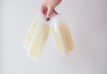  used wax strips on a white background shows a young woman with a beautiful manicure