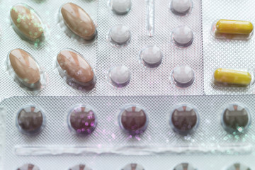 Vitamins and pills blister packs, close-up.