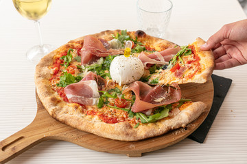 Pizza with mozzarella and raw ham