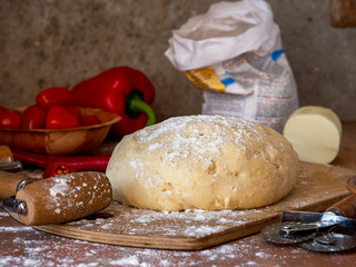 Fototapeta na wymiar Pizza yeast dough lying on a cutting board