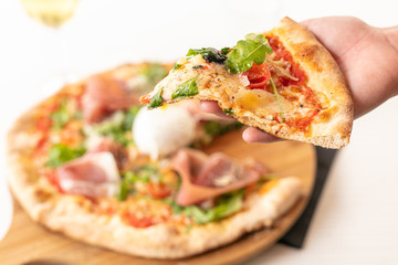 Pizza with mozzarella and raw ham