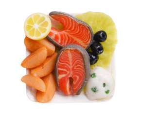 Realistic fake plasticine model of  food.  plate with salmon and fried potatoes made of polymer...