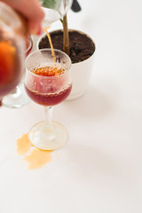 White background, flower in pot, strong black natural coffee in glassware prepared by alternative method from arabica beans.