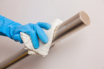 Disinfecting steel balustrade, cleaning house, healthcare routine