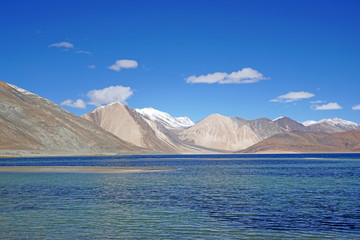 Lakescape  Nature Scene of Pangong tso or Pangong Lake with Snow mountain background is best famous destination at Leh Ladakh ,Jammu and Kashmir , India - Blue nature travel  Background - travel