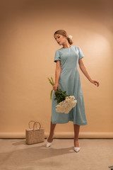 girl in blue dress on studio background with flowers, full body and portrait, spring, Fashion photo. Glamour lady © Bogdan