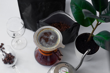 White background, flower in pot, strong black natural coffee in glassware prepared by alternative...